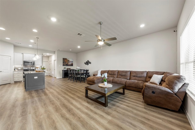 living room featuring light wood finished floors, recessed lighting, visible vents, and ceiling fan