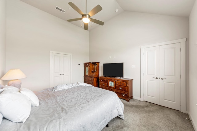 bedroom featuring light colored carpet, visible vents, ceiling fan, a closet, and high vaulted ceiling