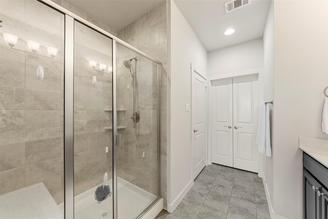 full bath with visible vents, a shower stall, vanity, and baseboards