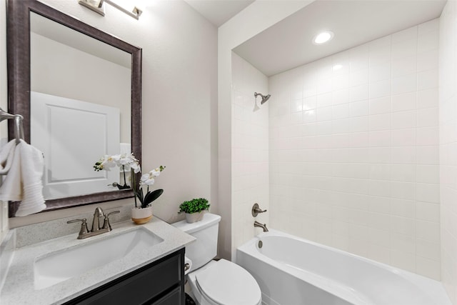 bathroom featuring recessed lighting, washtub / shower combination, toilet, and vanity