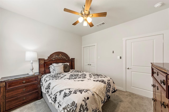 bedroom featuring a closet, visible vents, ceiling fan, and light carpet