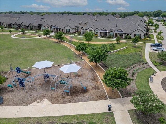 surrounding community featuring a residential view, a yard, and playground community