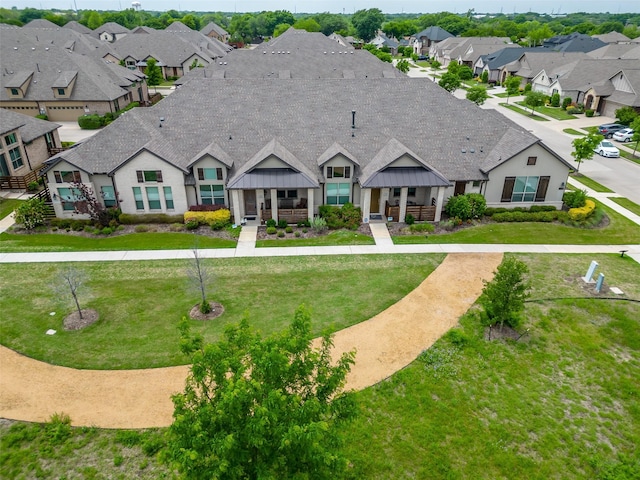 exterior space with a yard, a residential view, and stone siding