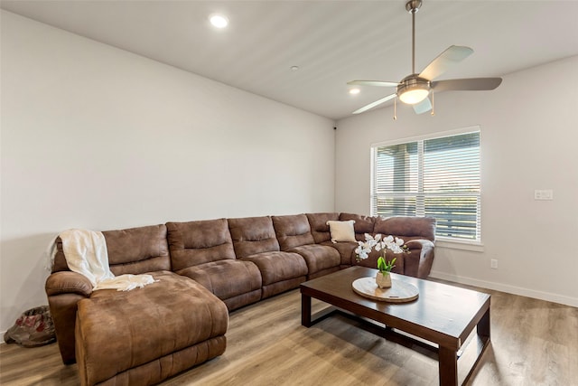 living area with light wood finished floors, a ceiling fan, recessed lighting, and baseboards