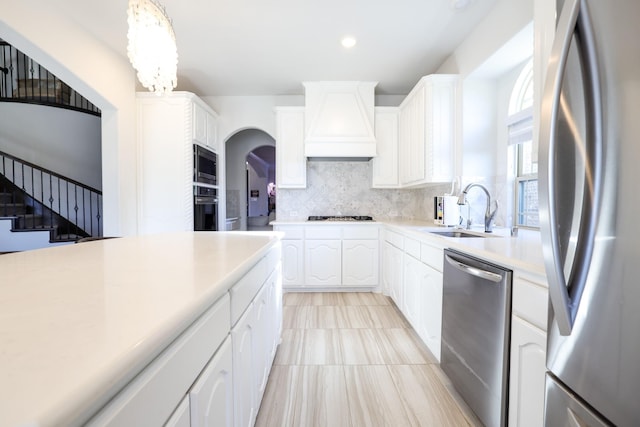 222 Crestview Dr, Midlothian, TX 76065 - kitchen featuring backsplash, a sink, custom exhaust hood, stainless steel appliances, and white cabinetry