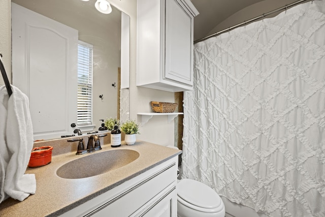 bathroom with vanity, toilet, and a shower with curtain