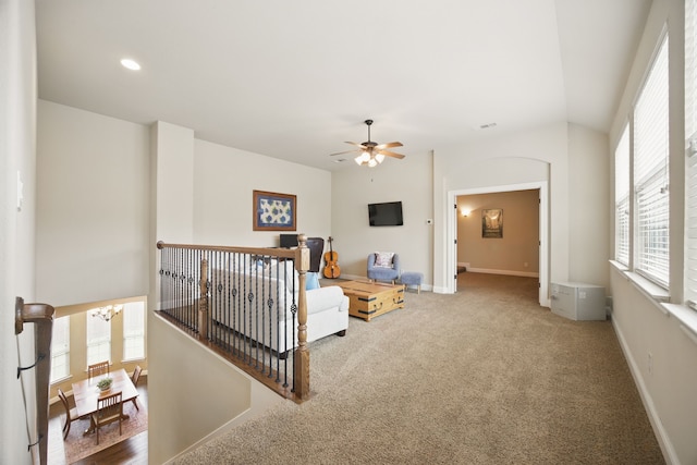 living room featuring carpet, ceiling fan, and baseboards