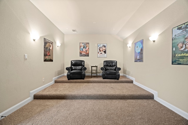 living area featuring carpet, visible vents, vaulted ceiling, and baseboards