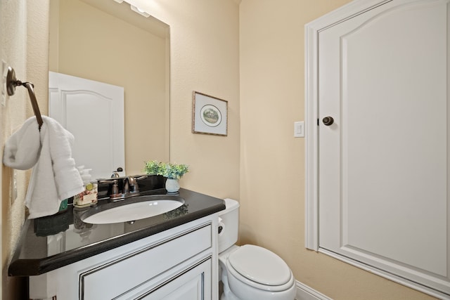 bathroom with toilet and vanity