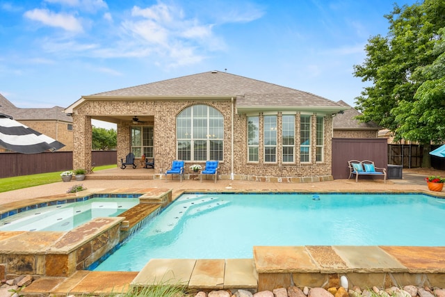 view of swimming pool featuring a patio area, a pool with connected hot tub, ceiling fan, and a fenced backyard