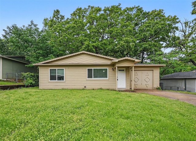 view of front of home featuring a garage, a front lawn, and concrete driveway
