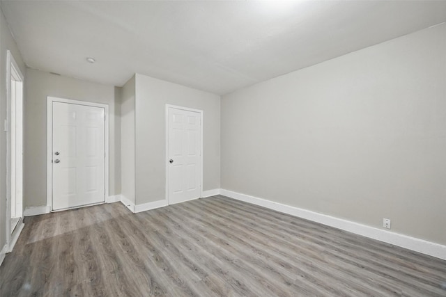 interior space featuring wood finished floors and baseboards