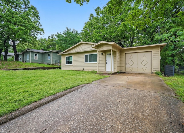 ranch-style house featuring a front lawn, a garage, and concrete driveway