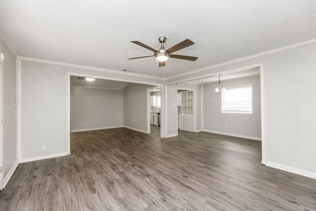 interior space featuring wood finished floors, ornamental molding, ceiling fan, visible vents, and a textured ceiling