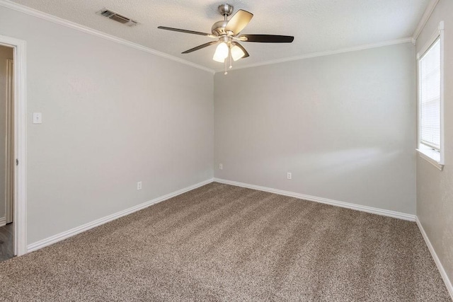 carpeted empty room featuring crown molding, a ceiling fan, visible vents, and a wealth of natural light