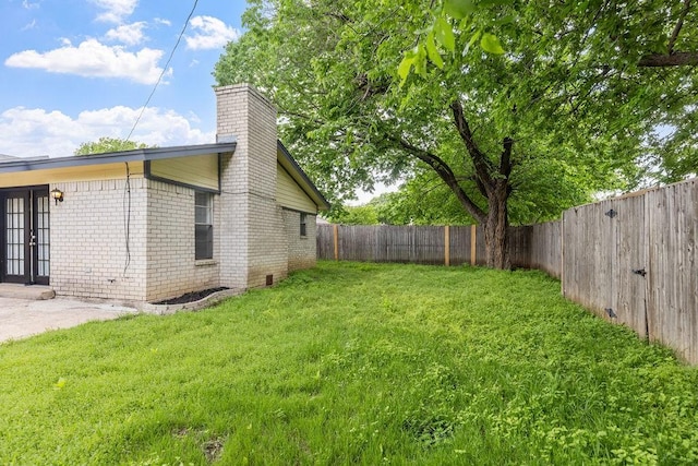 view of yard with a fenced backyard