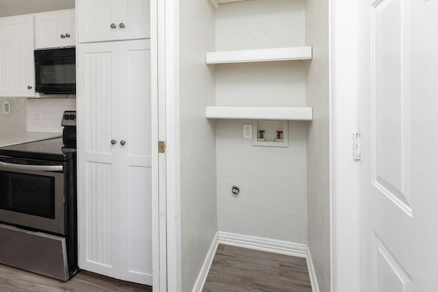washroom featuring washer hookup, wood finished floors, laundry area, and baseboards