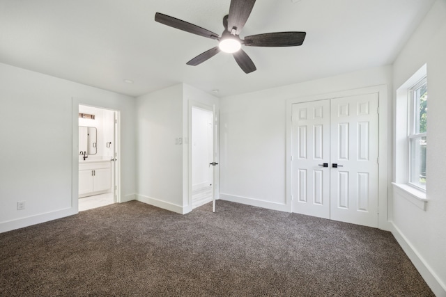 unfurnished bedroom with ceiling fan, a closet, carpet flooring, and baseboards