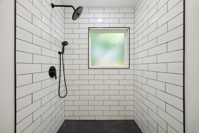 bathroom with a tile shower