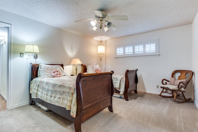 bedroom featuring a textured ceiling, carpet floors, and baseboards