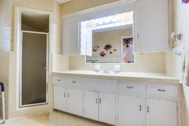 full bathroom with vanity, a shower stall, decorative backsplash, and tile patterned flooring
