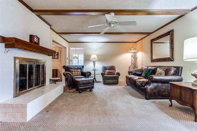 living area with beam ceiling, a fireplace, ceiling fan, crown molding, and carpet floors
