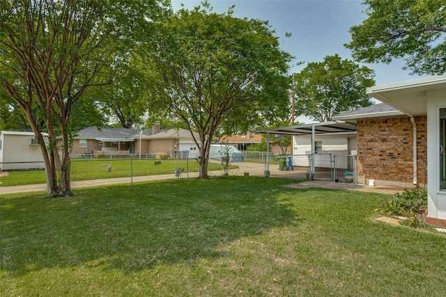 view of yard featuring fence and a gate
