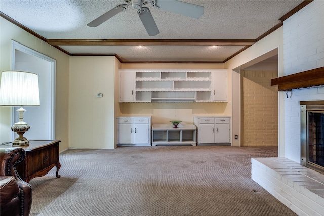 living room featuring beam ceiling, light carpet, a ceiling fan, and a brick fireplace