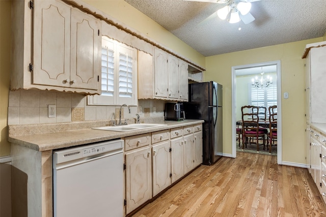 kitchen featuring decorative backsplash, dishwasher, light wood-style flooring, and a sink