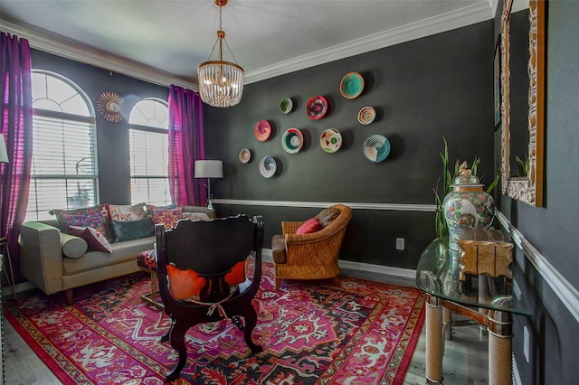 sitting room featuring crown molding, a chandelier, and wood finished floors