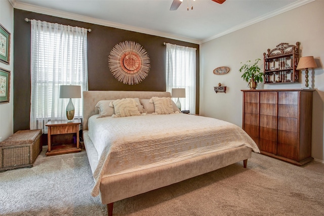 bedroom with ornamental molding, ceiling fan, and carpet