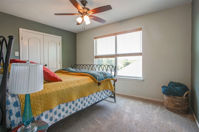 carpeted bedroom with a closet, ceiling fan, and baseboards