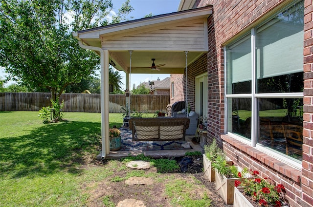 view of yard with ceiling fan, a patio, an outdoor hangout area, and a fenced backyard