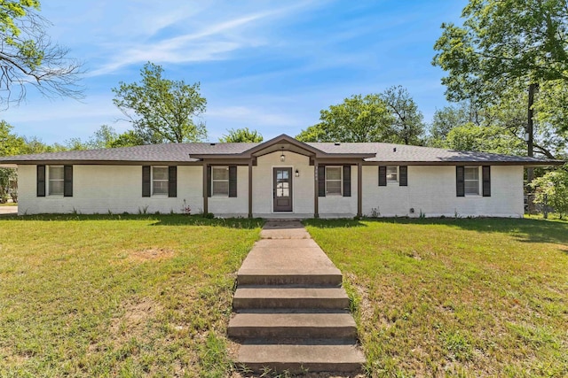 single story home featuring a front yard and brick siding