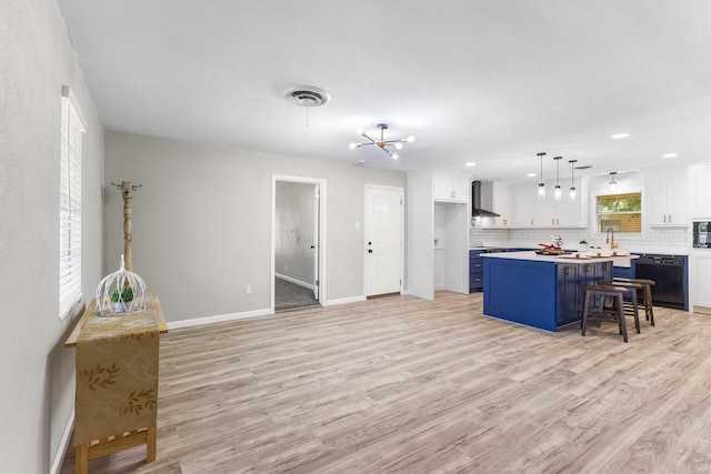 kitchen with black dishwasher, white cabinetry, blue cabinetry, and decorative backsplash