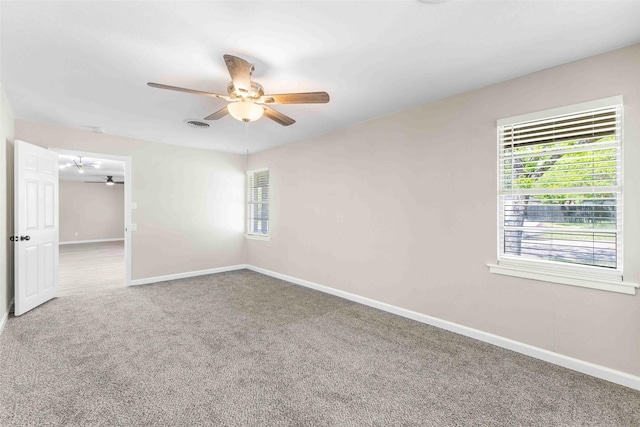 spare room with a ceiling fan, baseboards, and carpet floors
