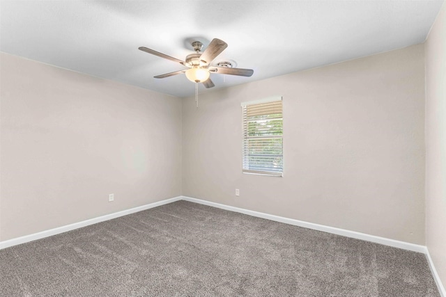 carpeted empty room with a ceiling fan and baseboards