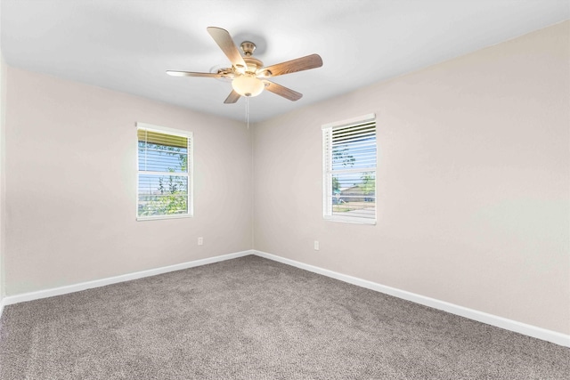 spare room with carpet flooring, ceiling fan, and baseboards