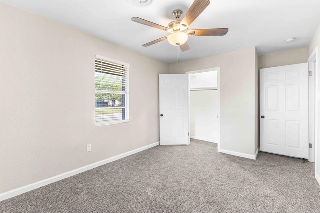 unfurnished bedroom with baseboards, ceiling fan, a closet, and carpet flooring