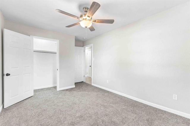 unfurnished bedroom with baseboards, a ceiling fan, carpet floors, and a closet