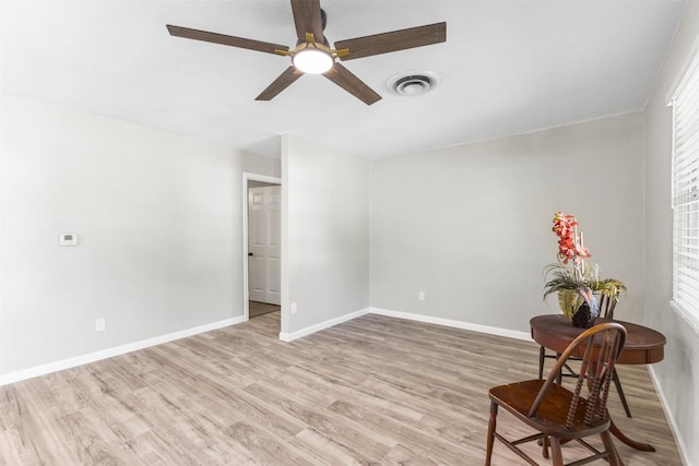 living area featuring visible vents, ceiling fan, light wood-style flooring, and baseboards