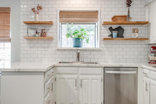 kitchen featuring a sink, open shelves, backsplash, and stainless steel dishwasher