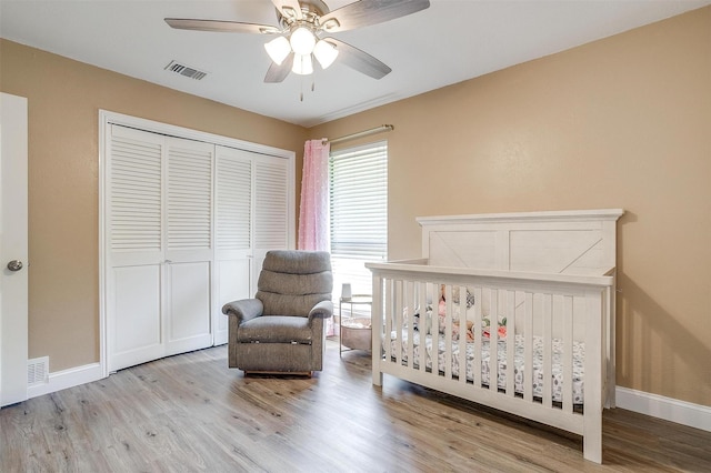 bedroom featuring visible vents, wood finished floors, and a closet