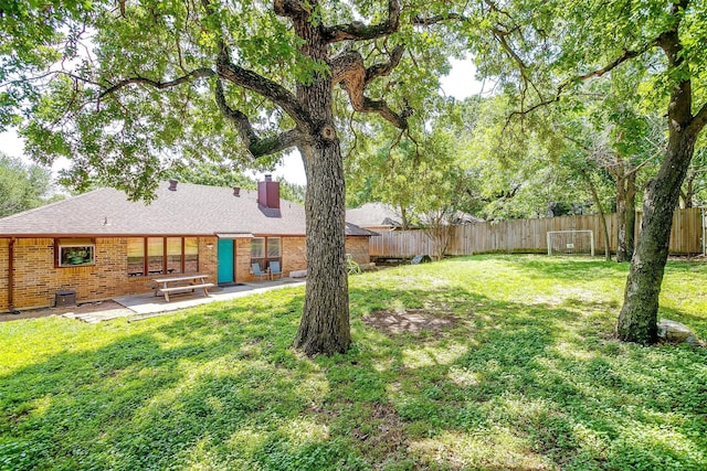 view of yard with a patio and a fenced backyard