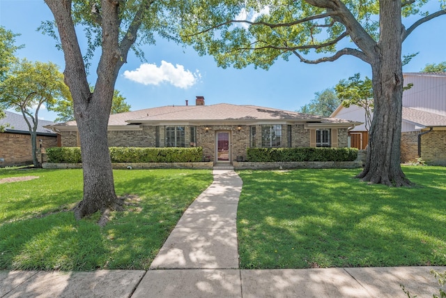 single story home featuring a front yard and brick siding