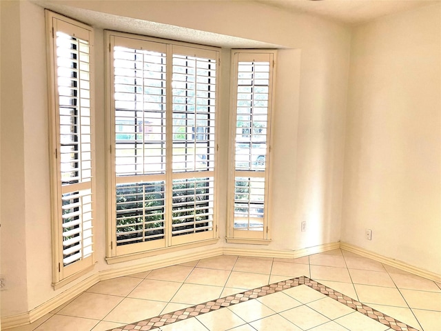 912 E Berkeley Dr, Richardson, TX 75081 - tiled spare room featuring baseboards and healthy amount of natural light