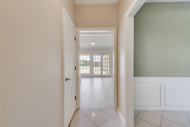 hall with light tile patterned floors
