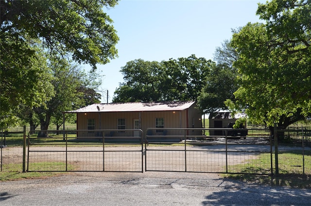 ranch-style home featuring metal roof and board and batten siding