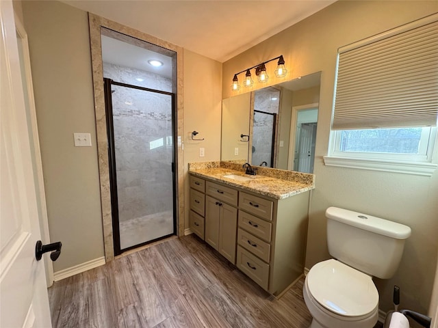 full bath featuring a stall shower, toilet, wood finished floors, and vanity