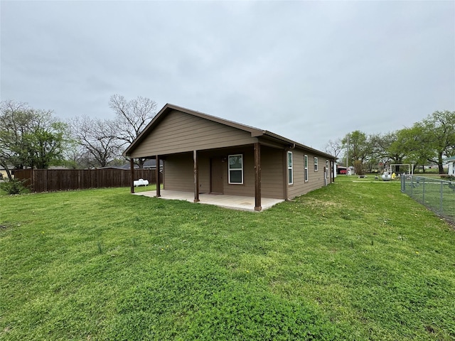 view of side of property featuring fence, a yard, and a patio area
